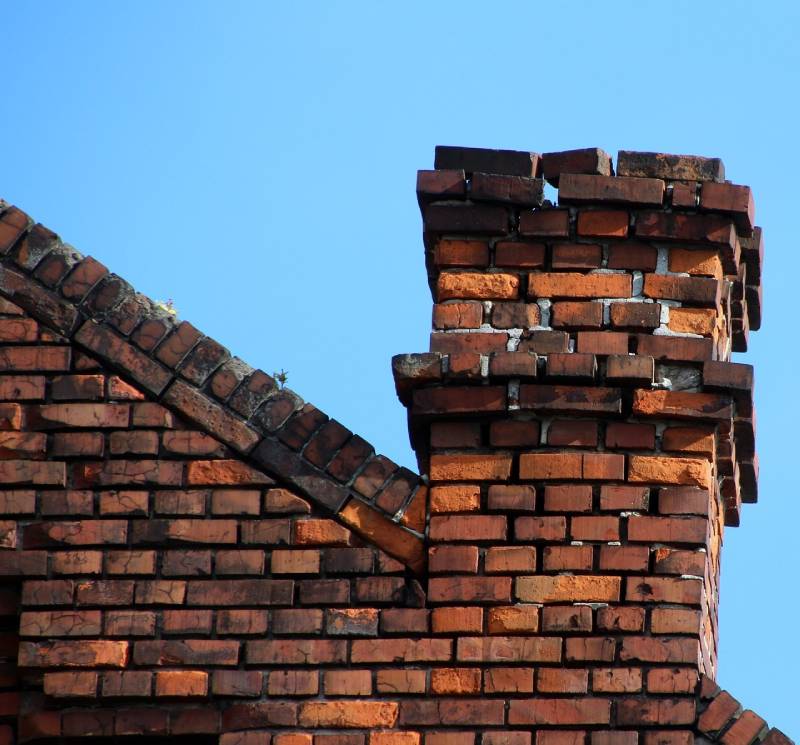 Signs Your Livonia Home Needs a Chimney Inspection Damaged chimney on an Livonia home showing cracks and missing mortar